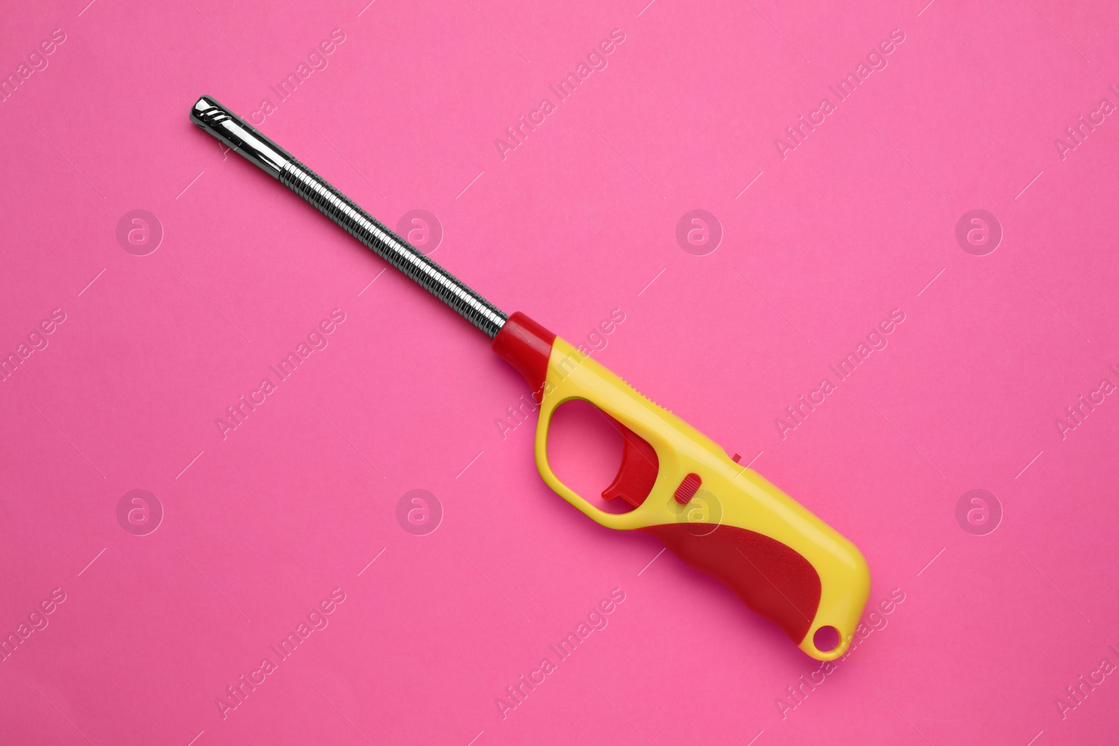 Photo of One gas lighter on pink background, top view