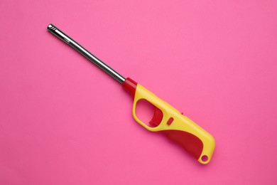 One gas lighter on pink background, top view