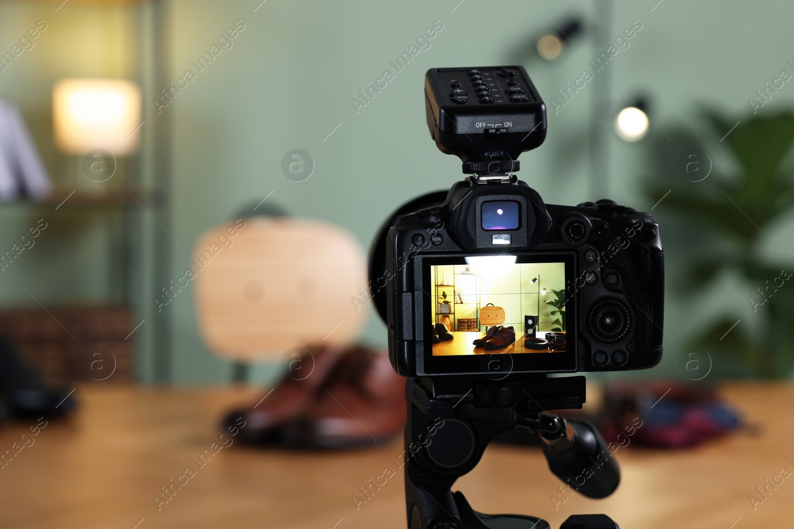 Photo of Beauty blogger's workplace. Men's accessories on table indoors, focus on camera