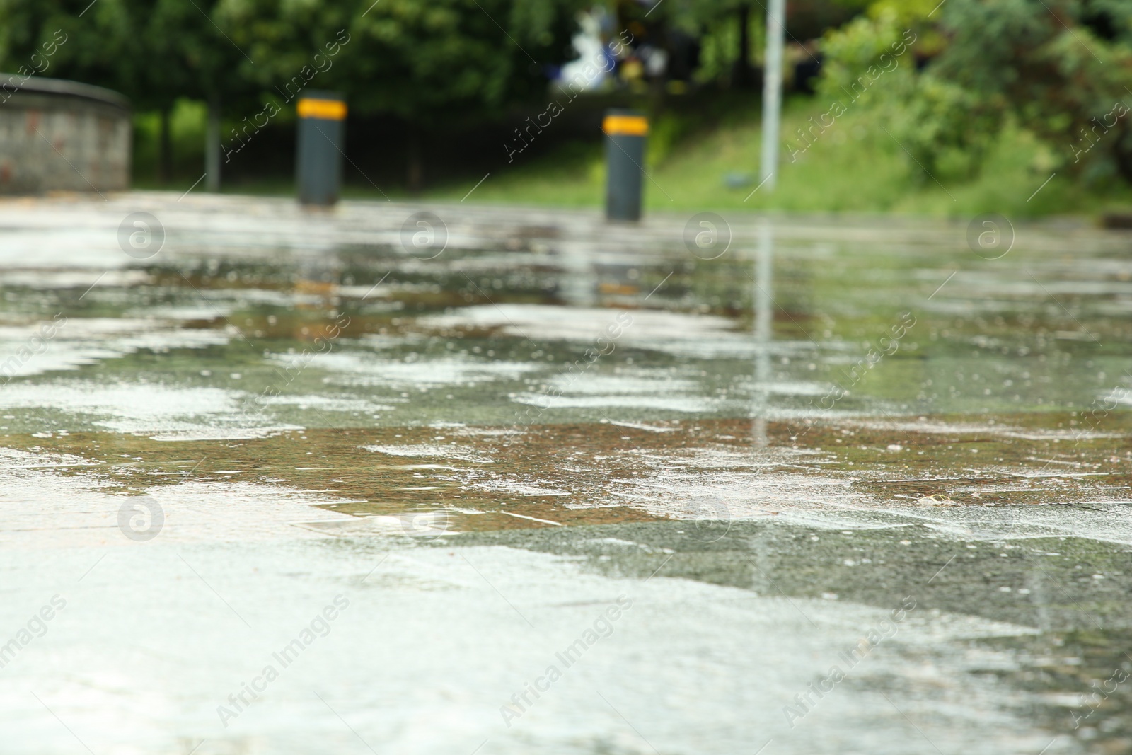 Photo of Puddles on street tiles after rain, closeup view