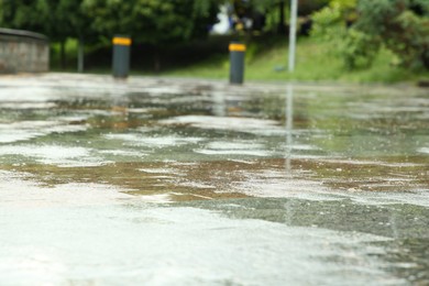 Photo of Puddles on street tiles after rain, closeup view