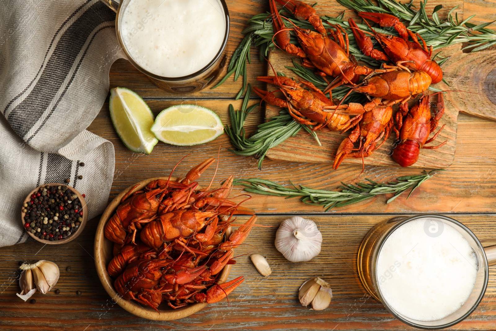 Photo of Flat lay composition with delicious red boiled crayfishes on wooden table