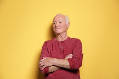 Photo of Portrait of elderly man on color background