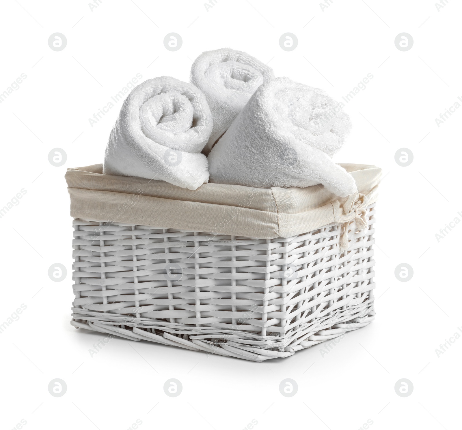 Photo of Rolled soft towels in basket on white background