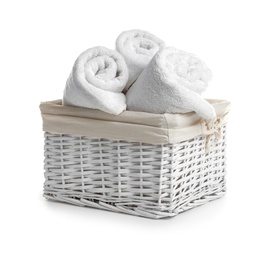 Rolled soft towels in basket on white background