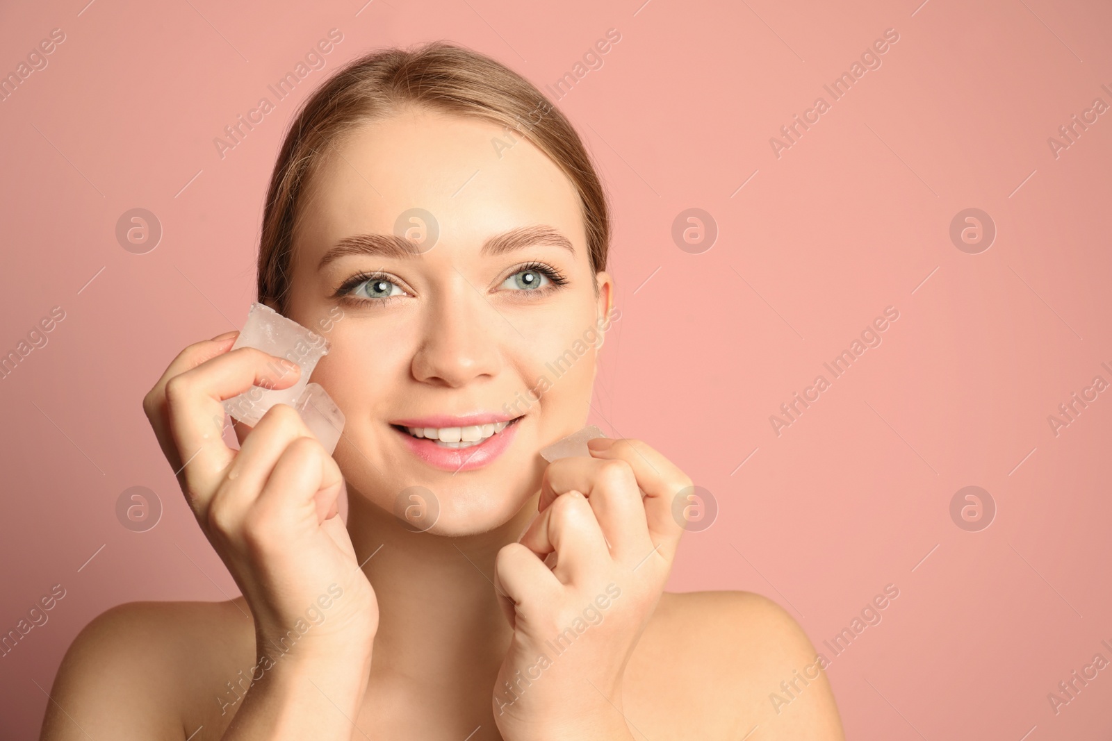 Photo of Young woman with ice cubes on color background, space for text. Skin care