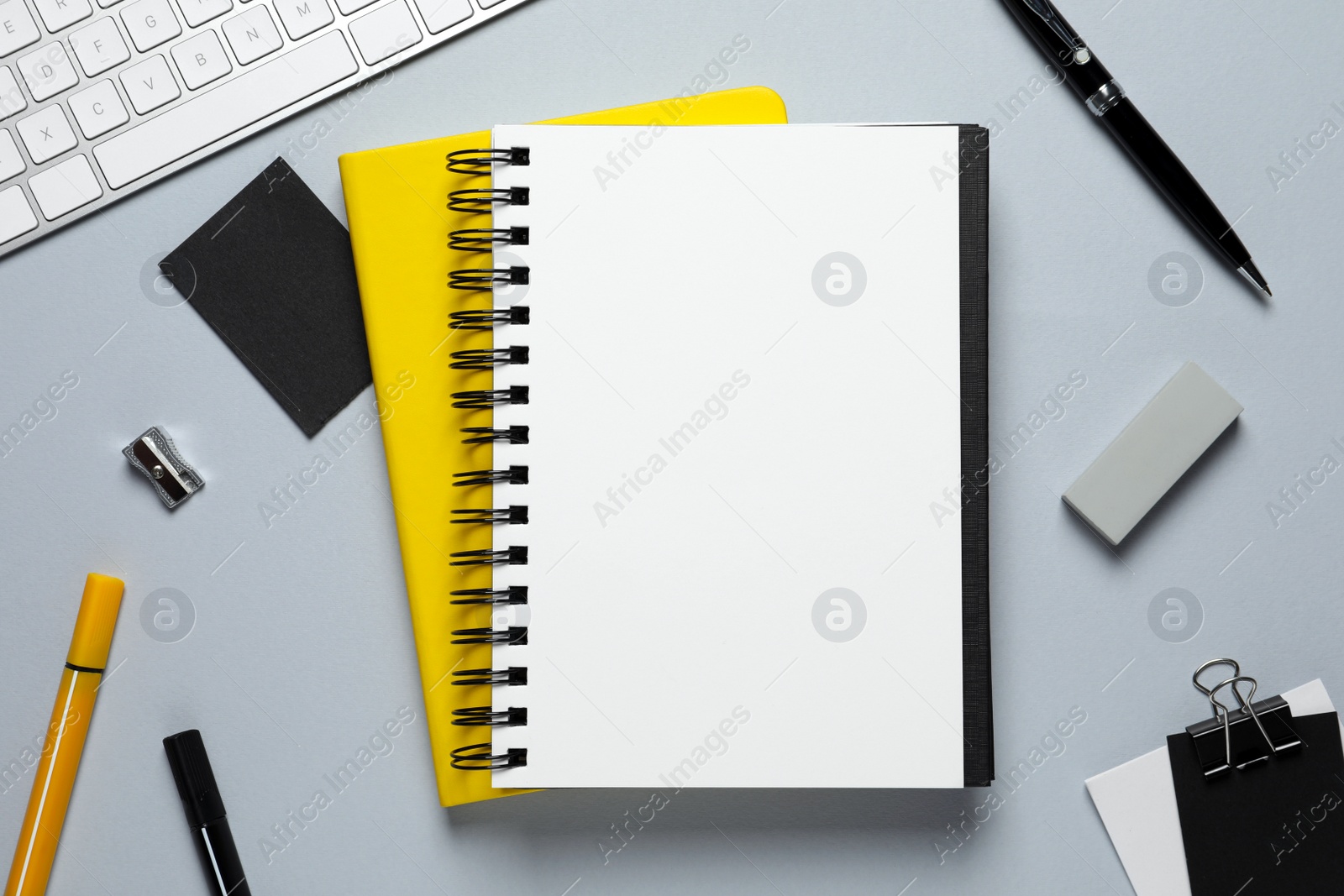 Photo of Flat lay composition with stylish notebooks on light grey table