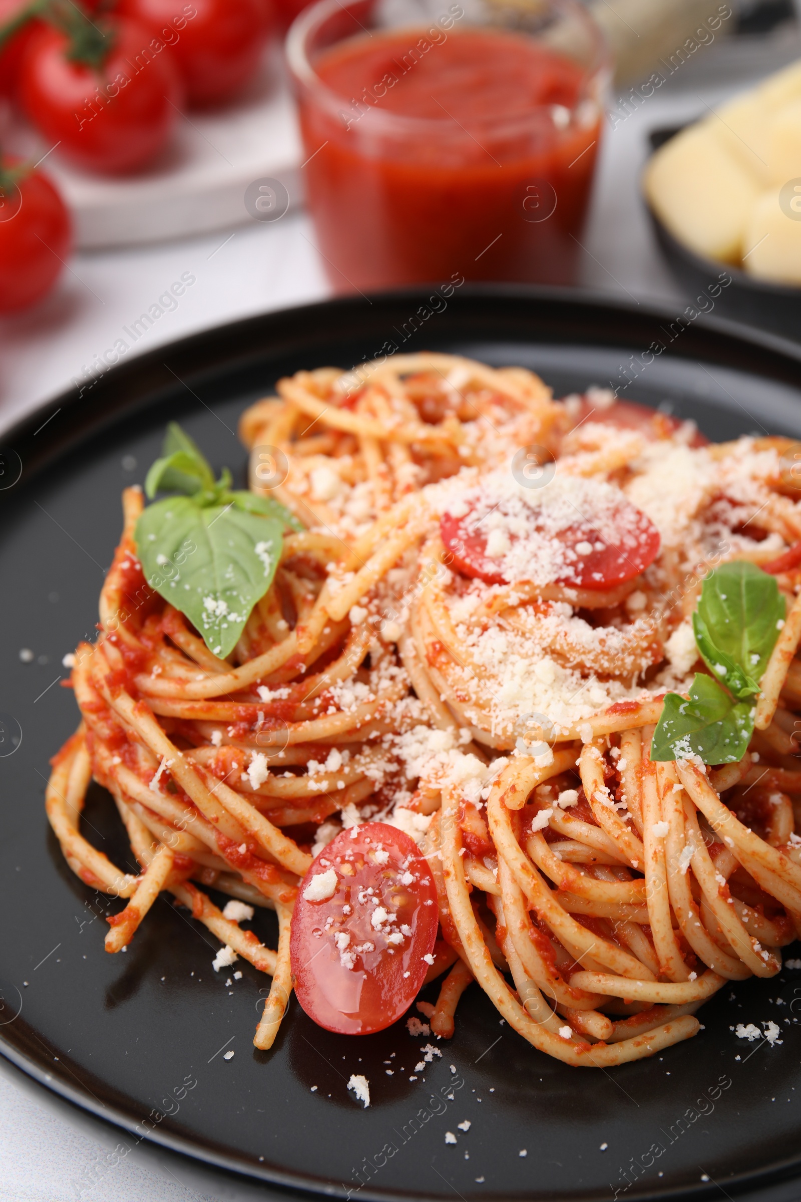 Photo of Tasty pasta with tomato sauce, cheese and basil on white table, closeup