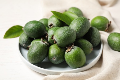Photo of Composition with fresh green feijoa fruits on white table, closeup
