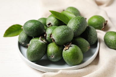 Composition with fresh green feijoa fruits on white table, closeup