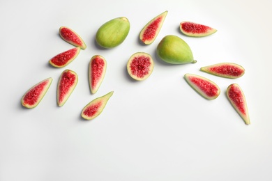 Flat lay composition with fresh ripe fig slices on white background. Space for text