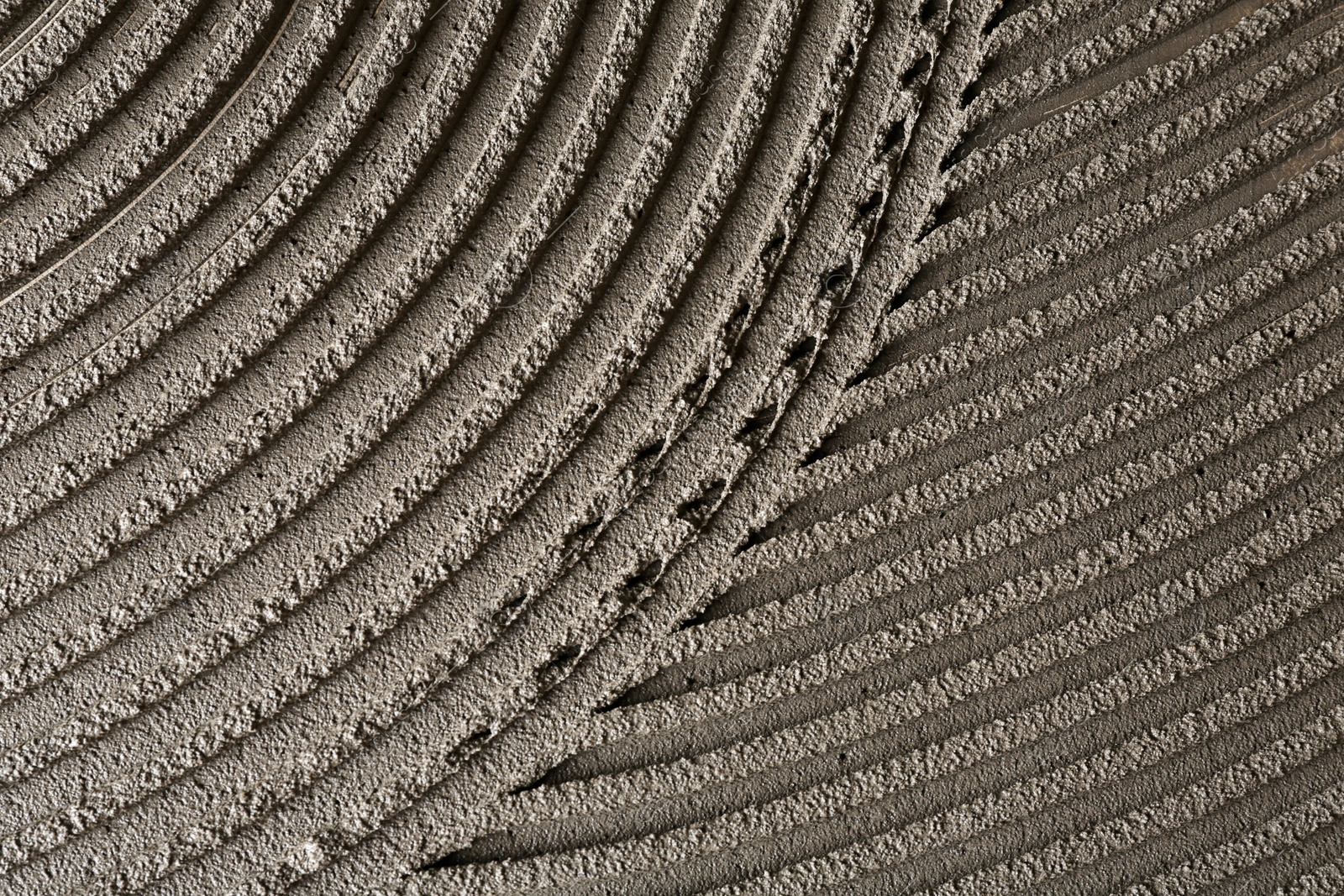 Photo of Lined grey concrete as background, top view. Tile installation