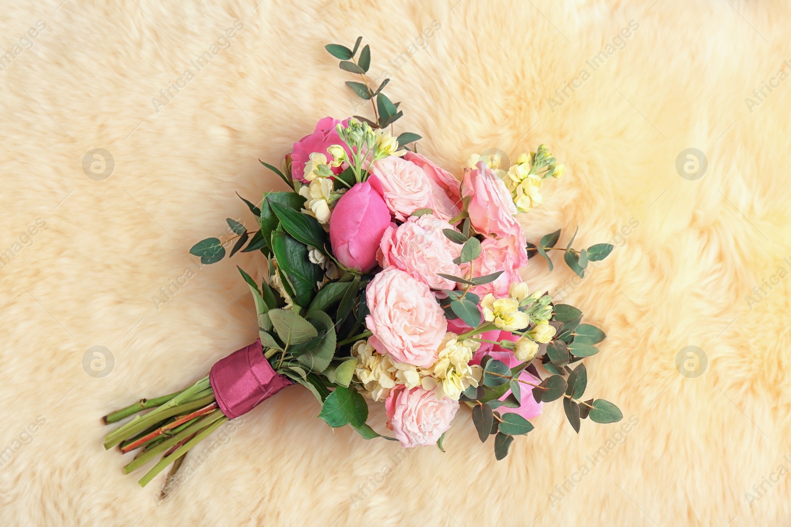 Photo of Bouquet of beautiful fragrant flowers on furry fabric