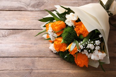 Image of Beautiful bouquet with orange peony tulips on wooden table, above view
