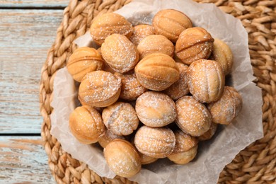 Photo of Bowl of delicious nut shaped cookies on grey wooden table, top view