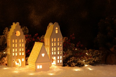 Photo of House shaped lanterns and Christmas decor on windowsill indoors