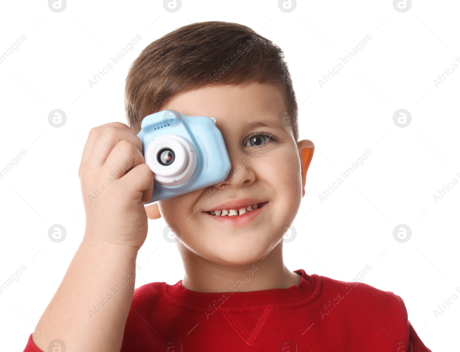 Photo of Little photographer taking picture with toy camera on white background