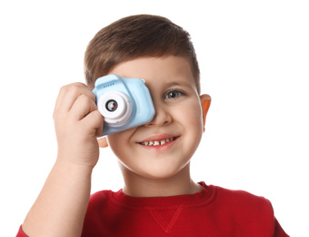 Little photographer taking picture with toy camera on white background