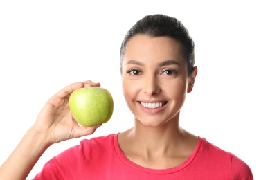 Young woman with healthy teeth and apple on white background