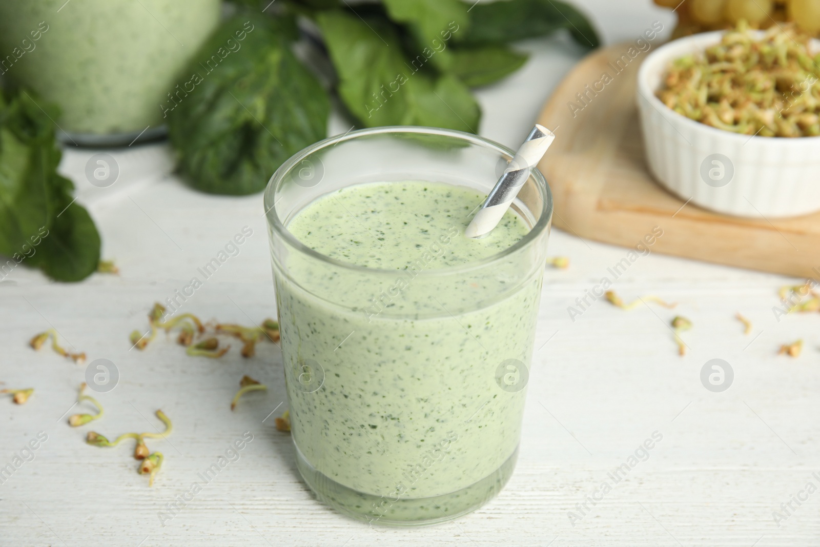 Photo of Green buckwheat smoothie on white wooden table