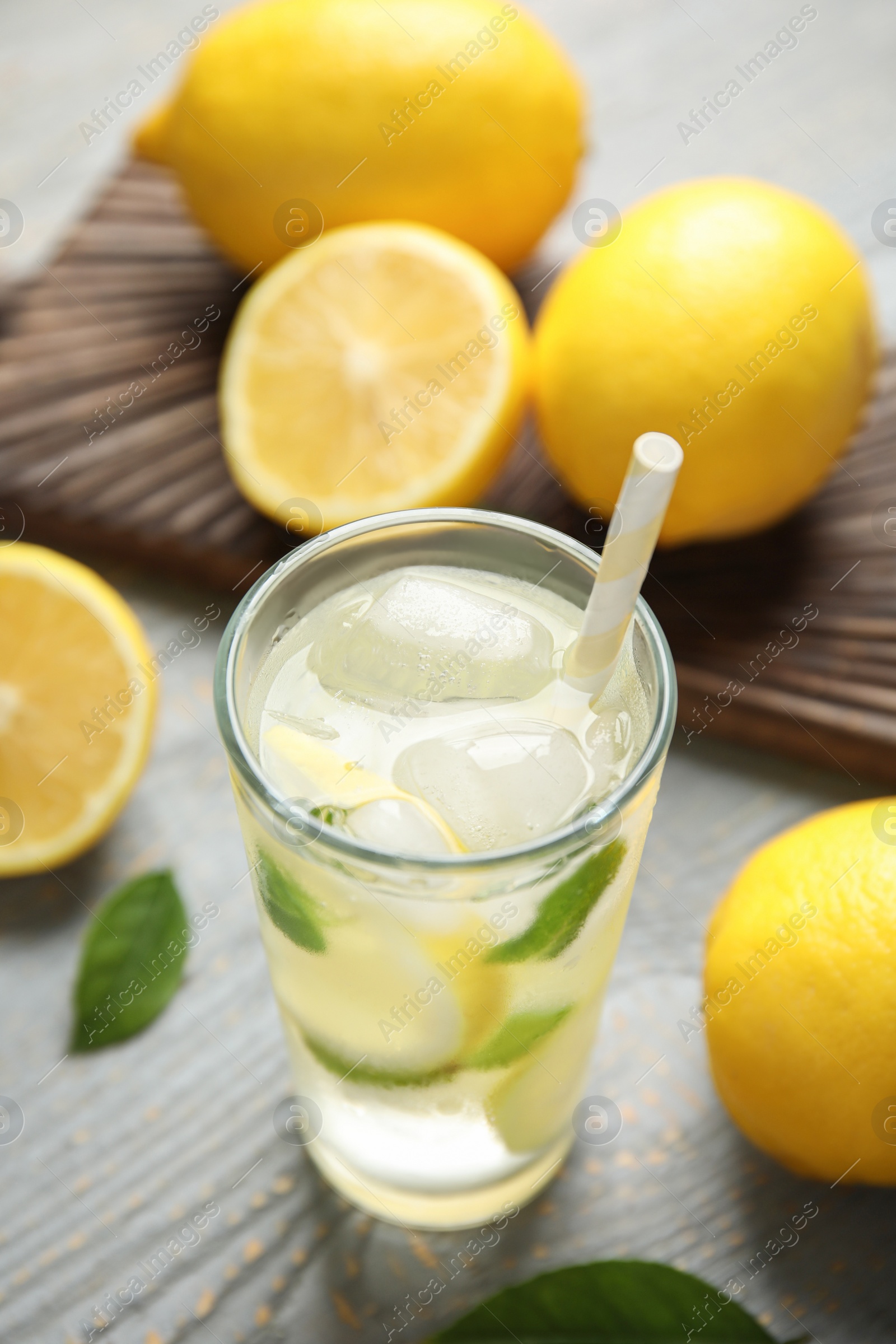 Photo of Cool freshly made lemonade and fruits on grey wooden table