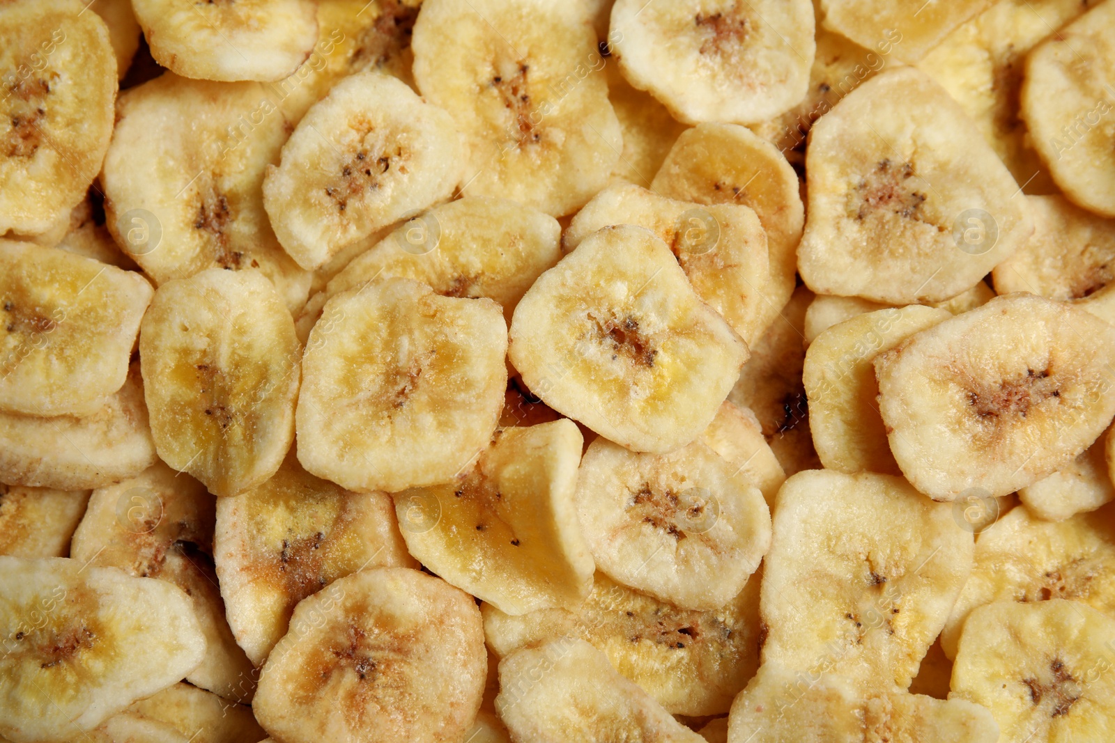 Photo of Sweet banana slices as background, top view. Dried fruit as healthy snack