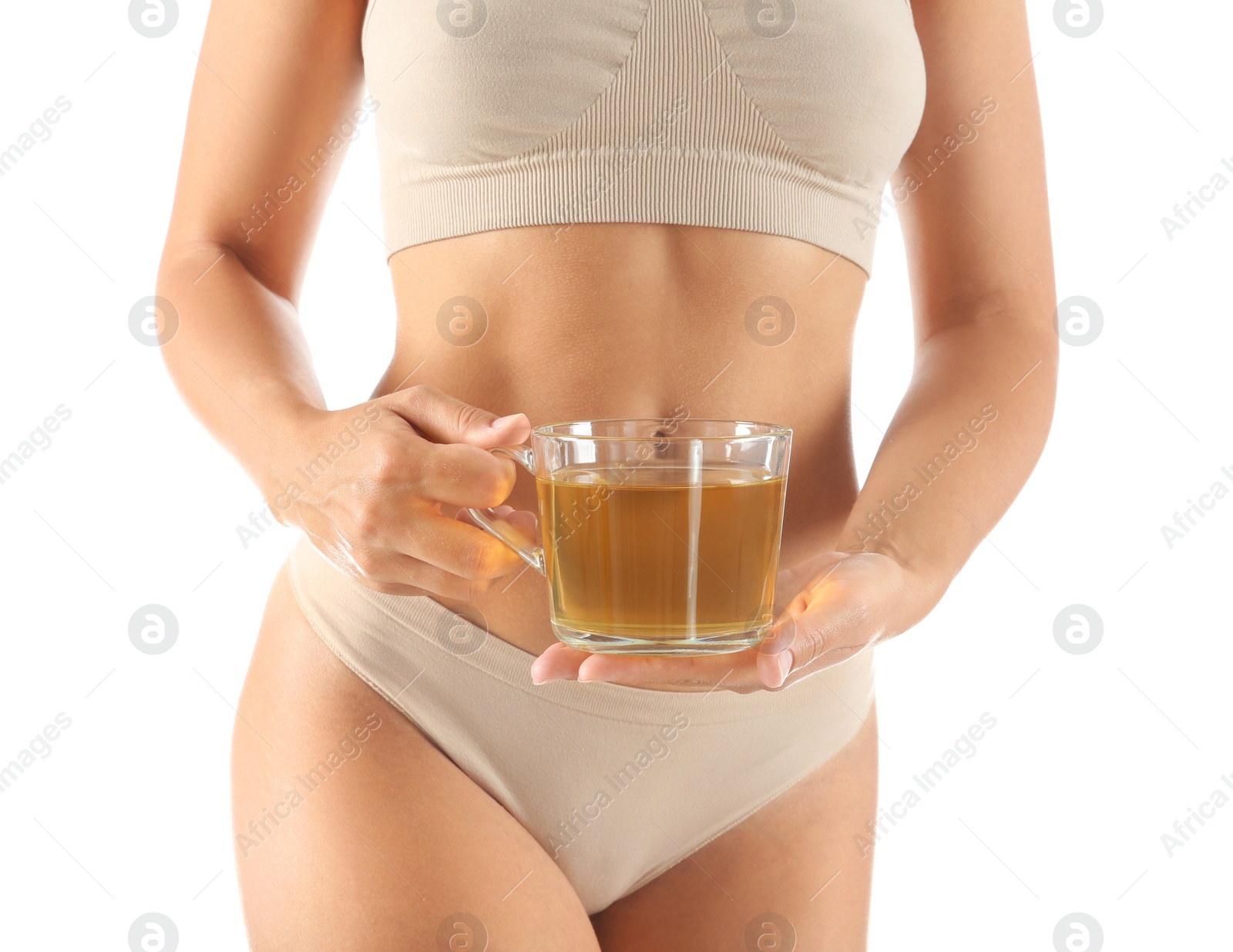 Photo of Young woman holding cup of diet tea on white background, closeup