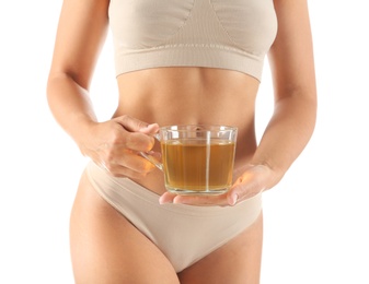 Photo of Young woman holding cup of diet tea on white background, closeup