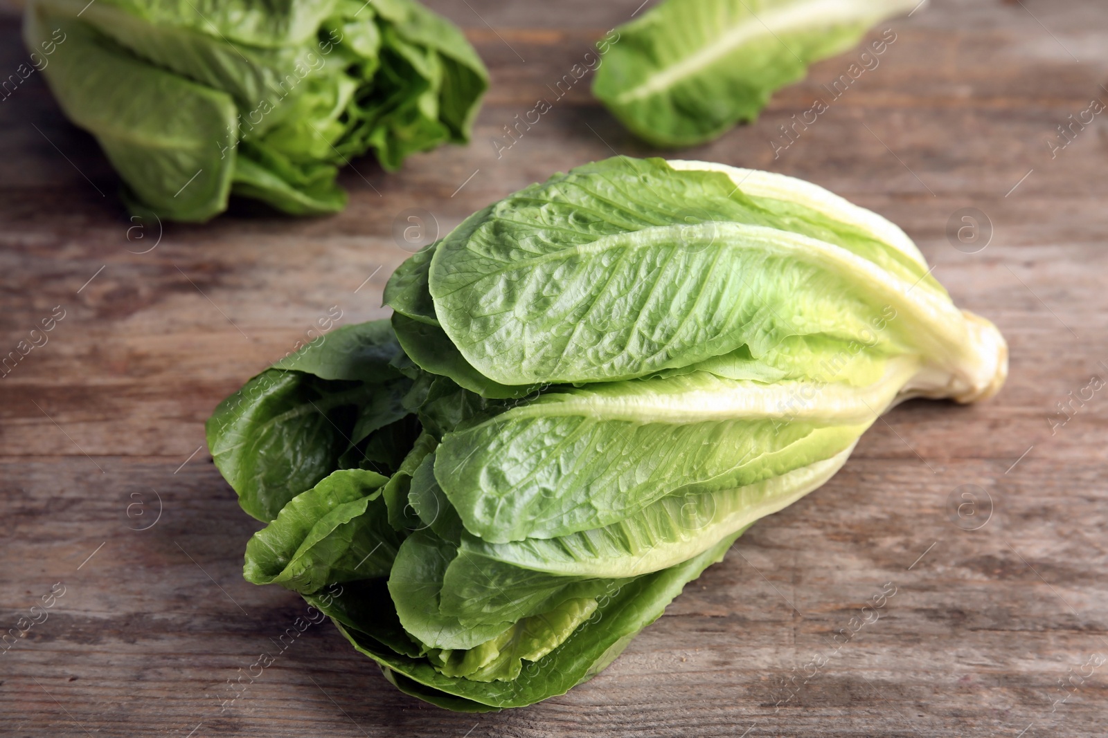 Photo of Fresh ripe cos lettuce on wooden table