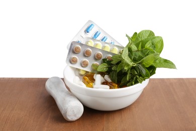 Board with mortar, fresh mint and pills on white background