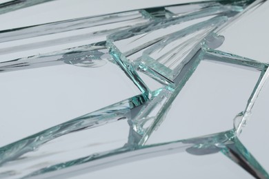 Photo of Broken mirror with many cracks as background, closeup view