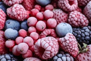 Photo of Mix of different frozen tasty berries as background, closeup