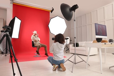 Photo of Handsome model posing for professional photographer in studio