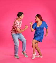 Photo of Beautiful lovely couple dancing on pink background