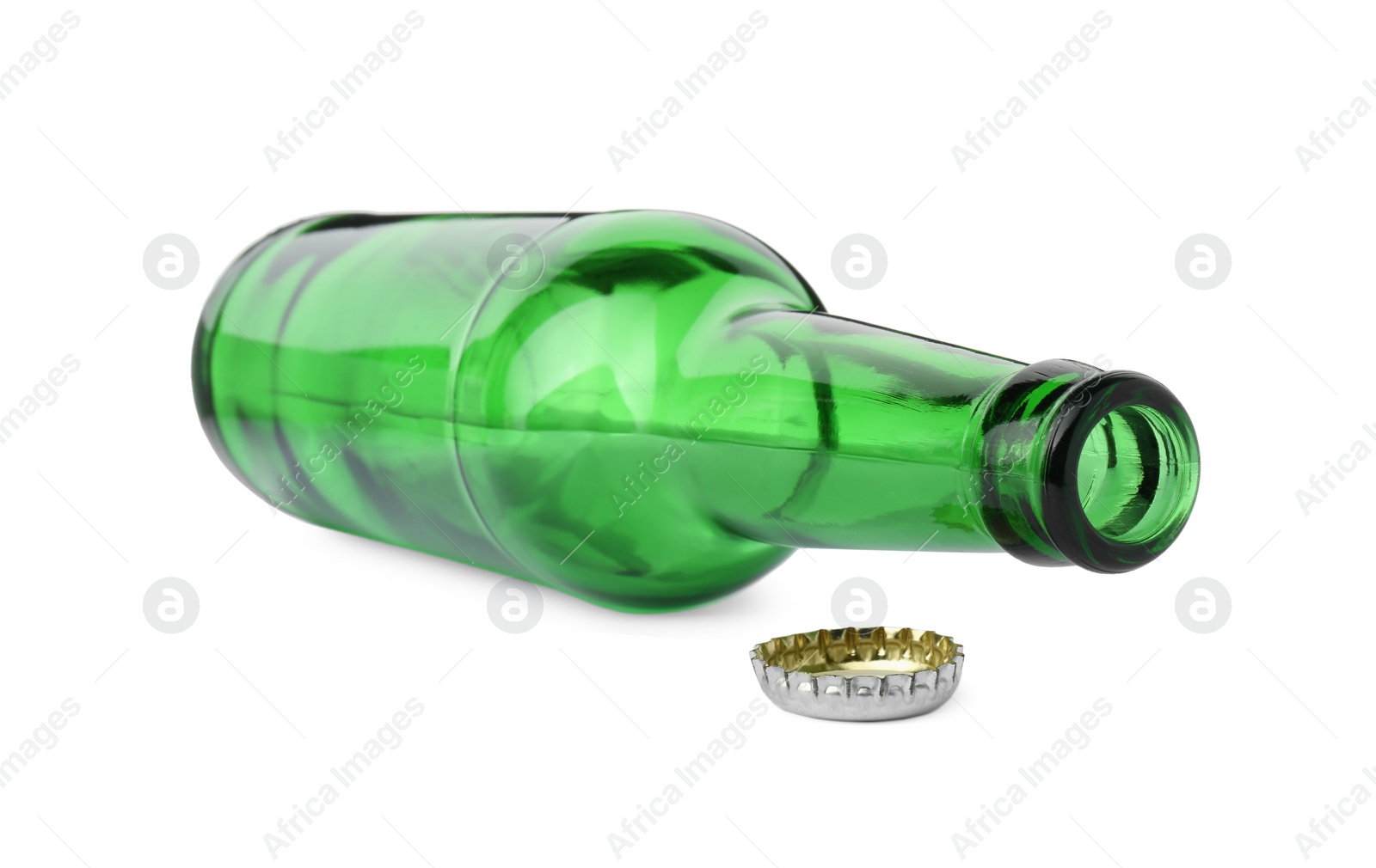 Photo of One empty green beer bottle and cap isolated on white