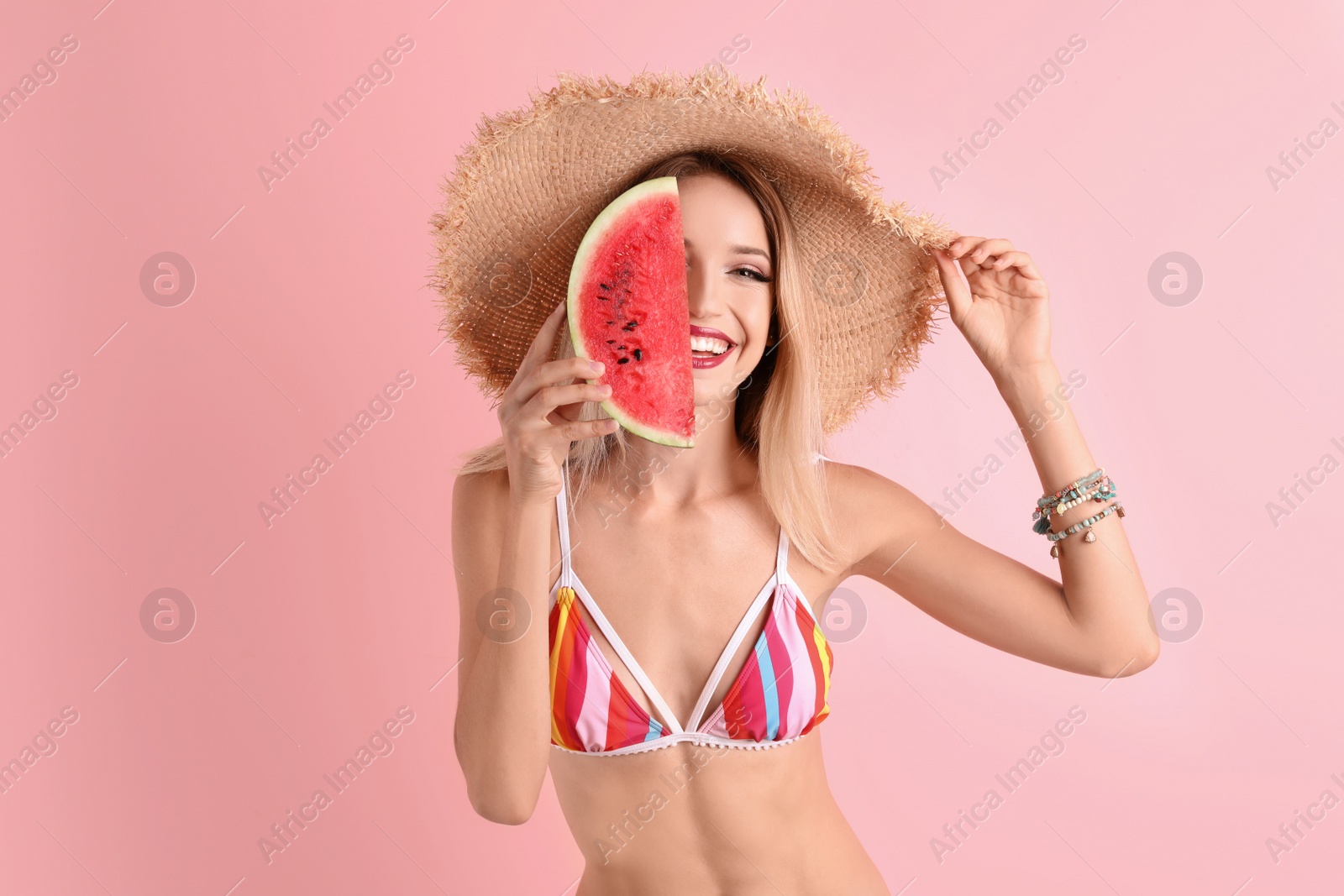 Photo of Pretty young woman with juicy watermelon on color background