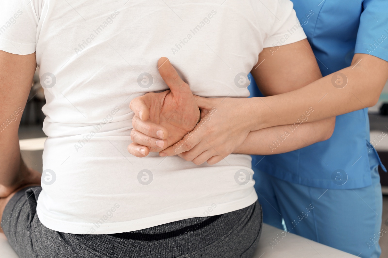 Photo of Physiotherapist working with patient in clinic, closeup. Rehabilitation therapy