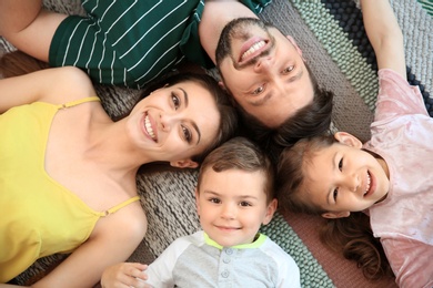 Photo of Portrait of happy family with children indoors, top view