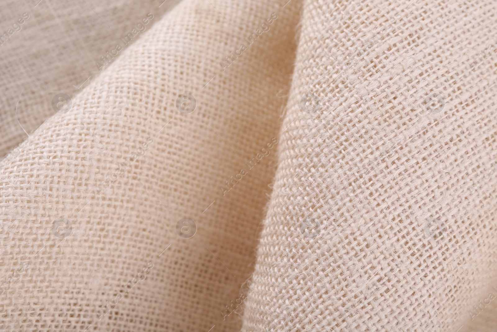 Photo of Texture of beige burlap fabric, closeup view