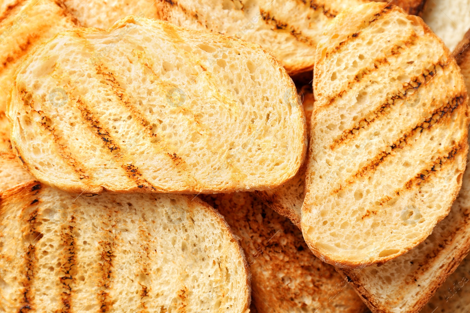 Photo of Toasted slices of bread as background, closeup