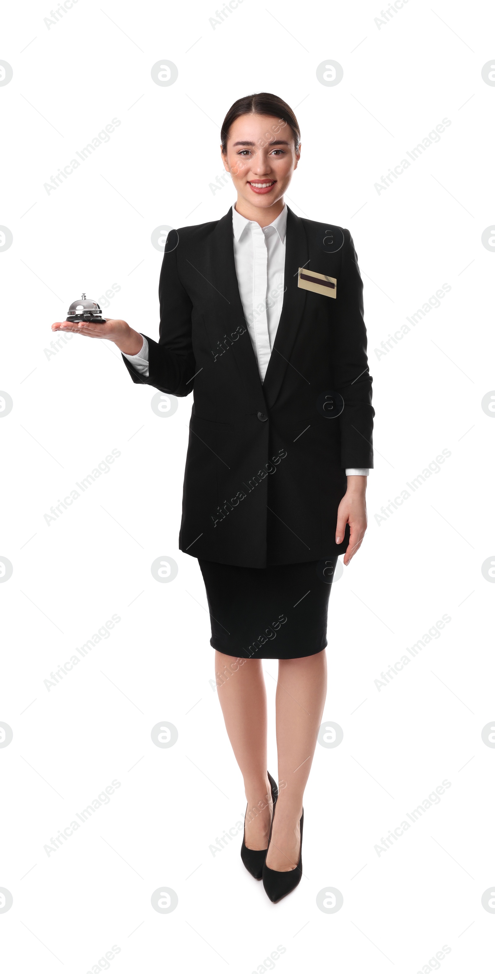 Photo of Happy young receptionist in uniform holding service bell on white background