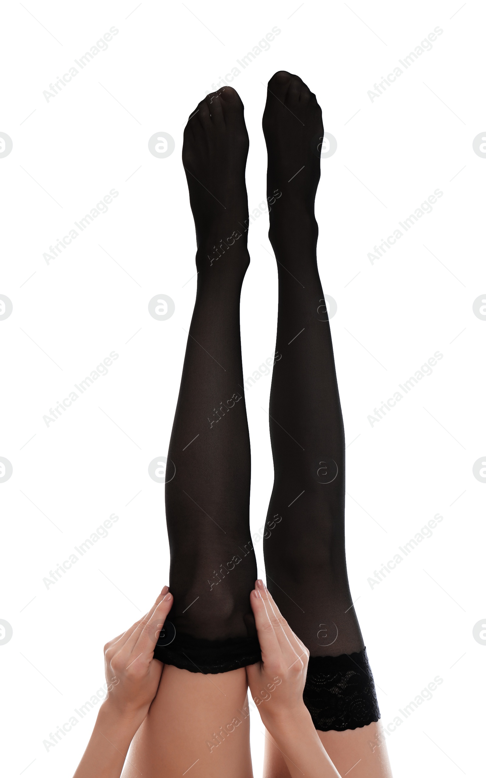 Photo of Young woman putting on stocking against white background, closeup