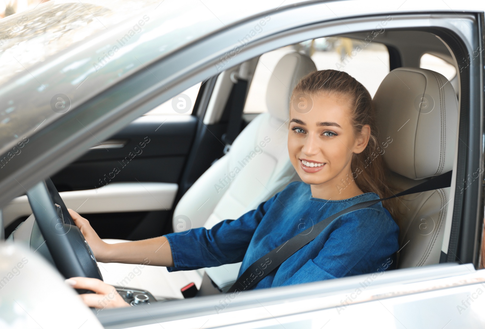 Photo of Female driver with fastened safety belt in car