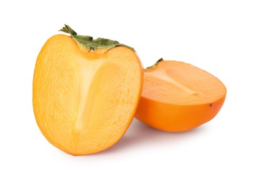 Photo of Halves of delicious ripe juicy persimmons on white background