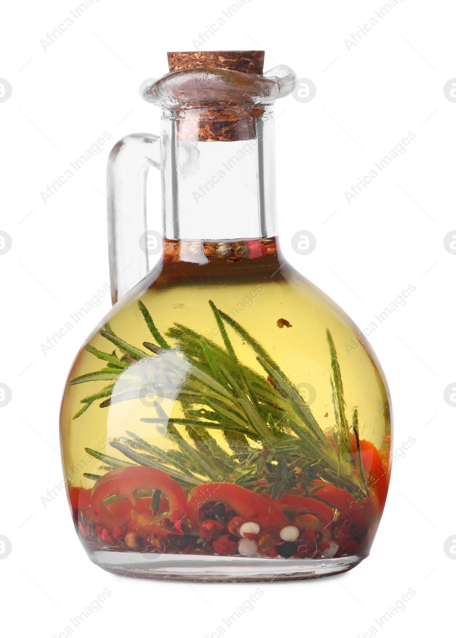 Photo of Glass jug of cooking oil with spices and herbs isolated on white