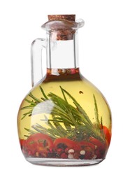 Glass jug of cooking oil with spices and herbs isolated on white