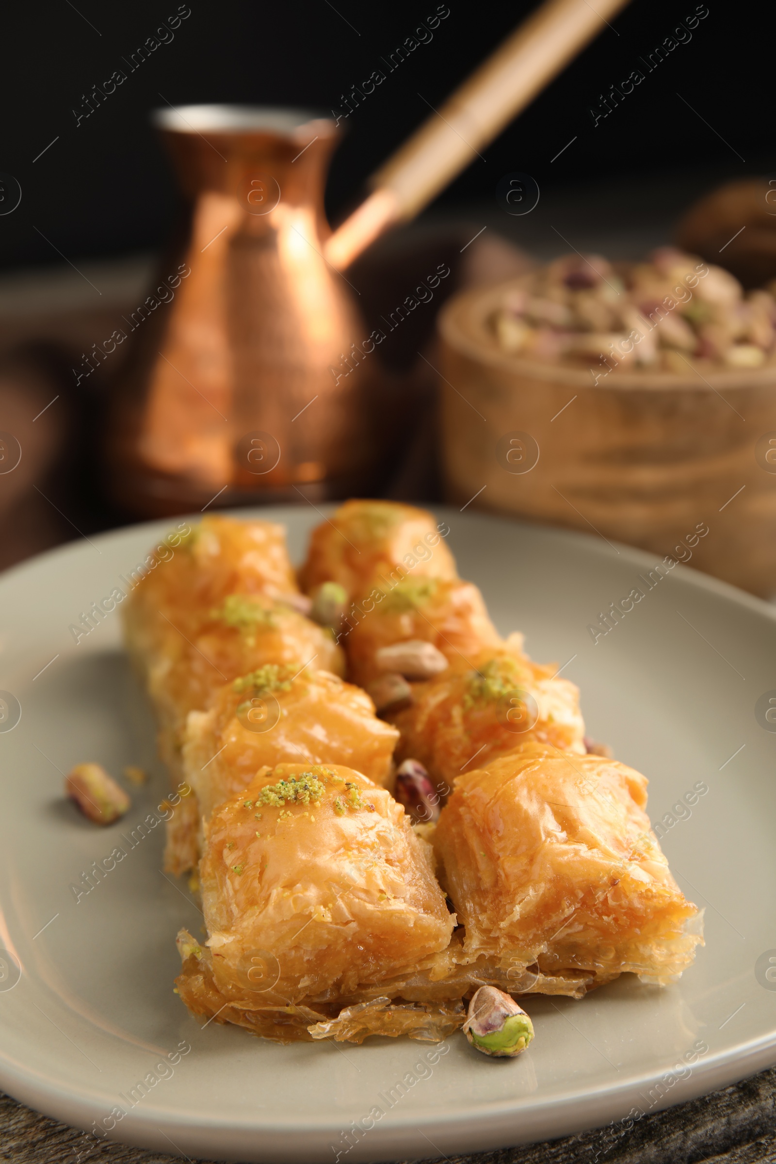 Photo of Delicious baklava with pistachio nuts on table, closeup