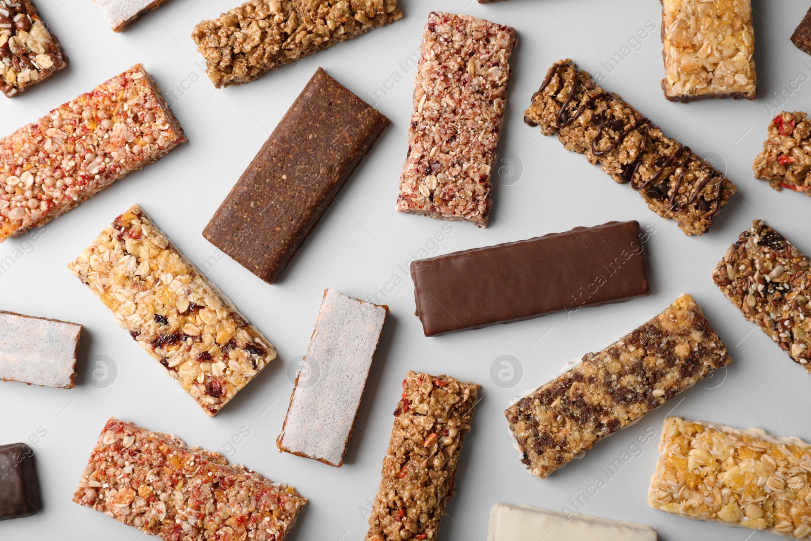 Photo of Flat lay composition with protein bars on grey background