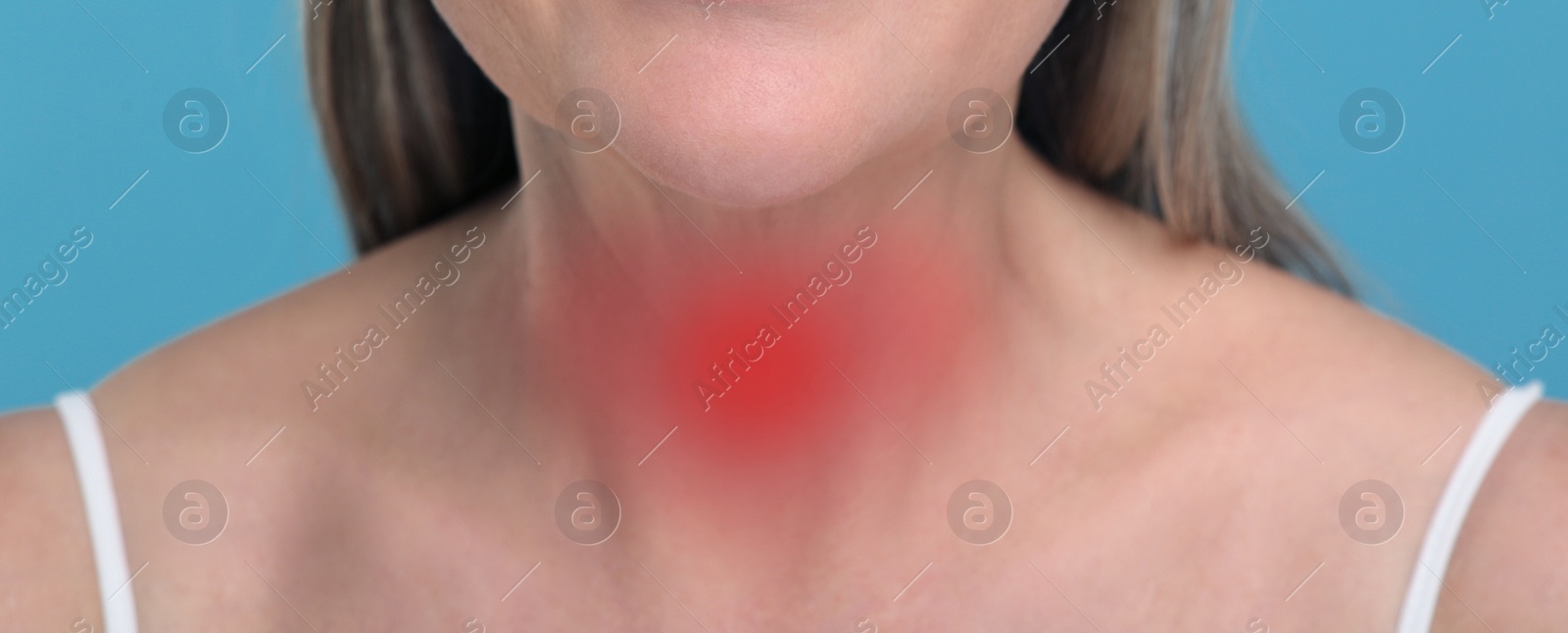Image of Endocrine system. Woman suffering from pain in thyroid gland on light blue background, closeup. Banner design