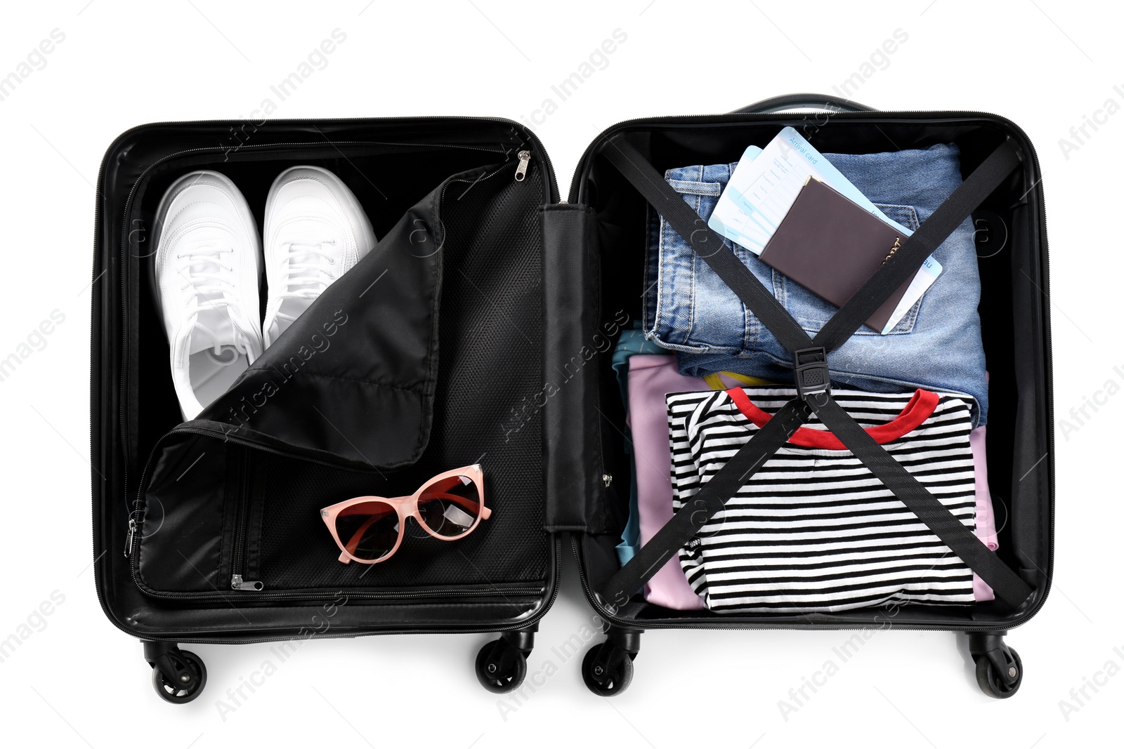 Photo of Open suitcase packed for travelling on white background, top view